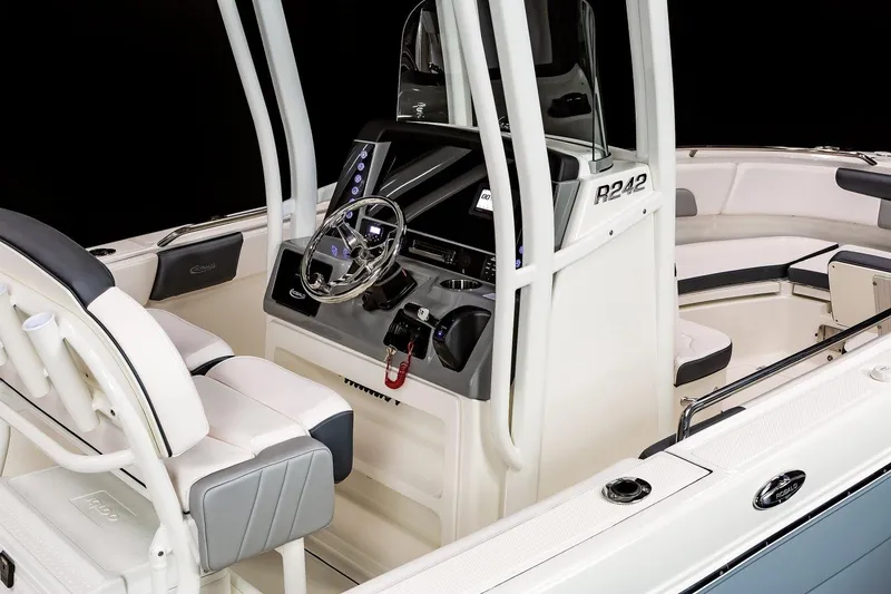 Slide: The Image of Manufacturer Provided Image: 2023 Robalo R242 Explorer boat interior with helm and seating. - 13