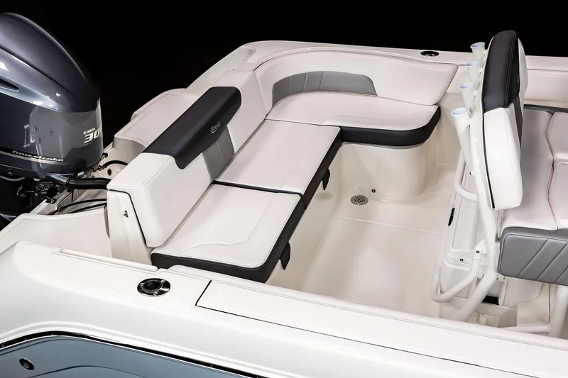 Slide: The Image of Manufacturer Provided Image: 2023 Robalo R242 Explorer boat interior with cushioned seating and outboard motor. - 17