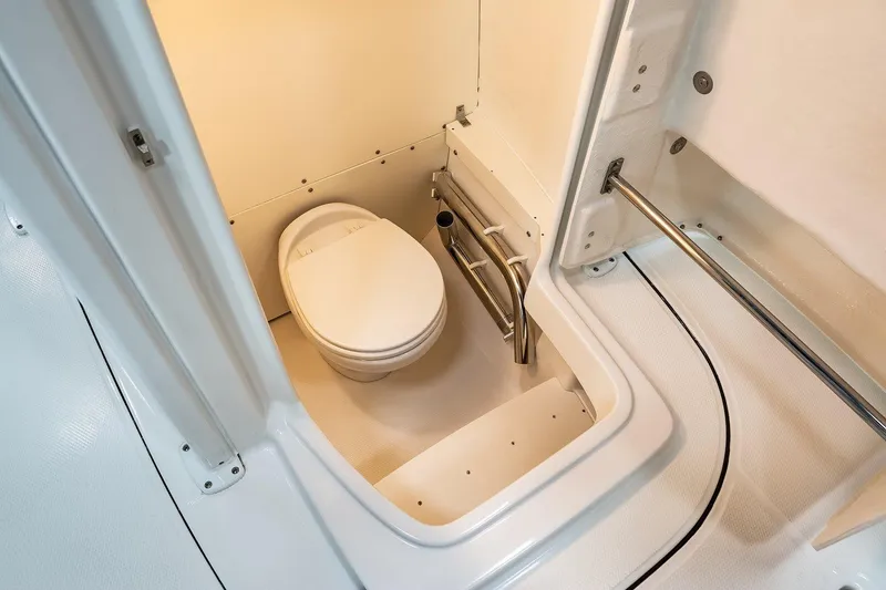 Slide: The Image of Manufacturer Provided Image: 2023 Robalo R242 Explorer boat interior bathroom with toilet. - 19