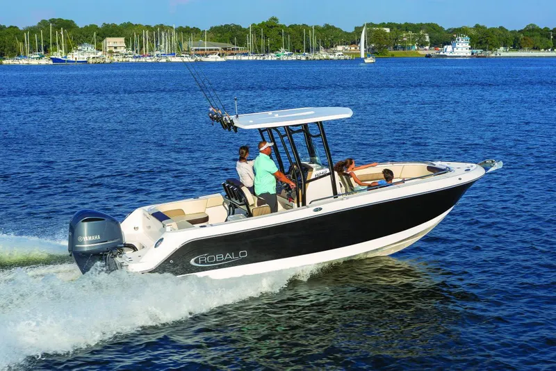 Slide: The Image of Manufacturer Provided Image: 2023 Robalo R242 Explorer boat cruising on a lake with passengers. - 7