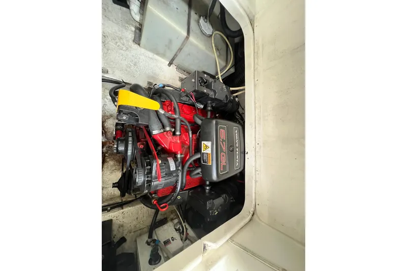 Slide: The Image of Engine compartment of a 2002 Larson Cabrio 254 boat, featuring a Volvo Penta 5.7L engine. - 20