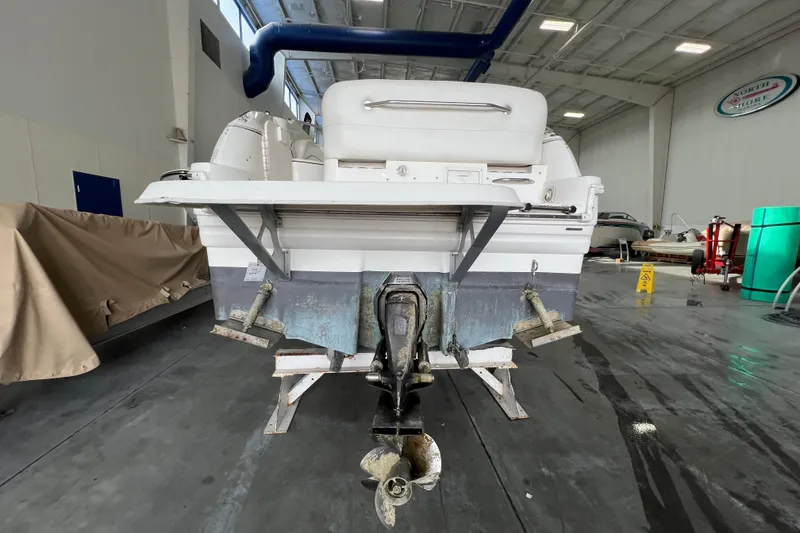 Slide: The Image of Rear view of a 2002 Larson Cabrio 254 boat in a storage facility. - 4