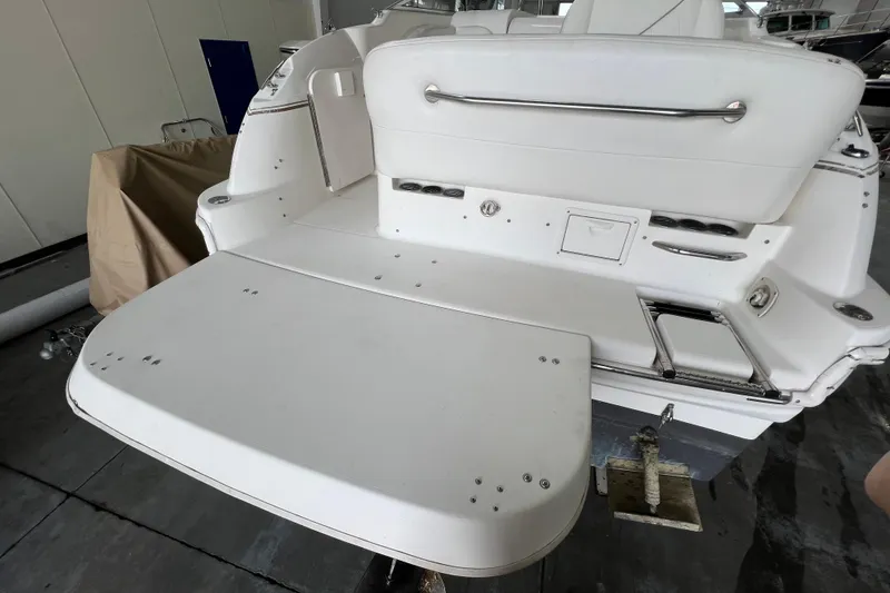 Slide: The Image of 2002 Larson Cabrio 254 boat stern with swim platform in a storage facility. - 6
