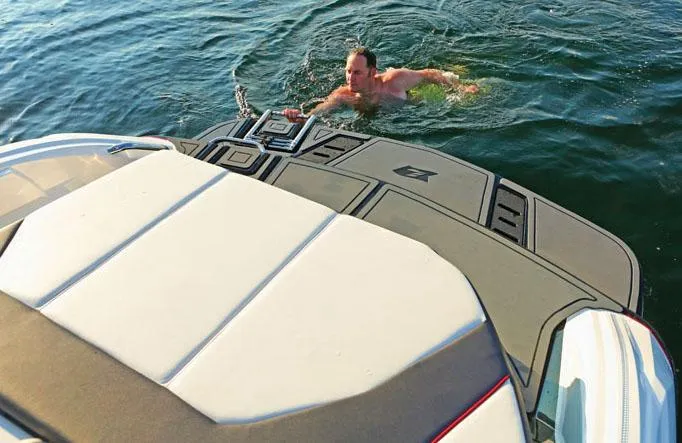 Slide: The Image of Manufacturer Provided Image: Man swimming near a 2013 Larson LSR 2300 I/O boat. - 5
