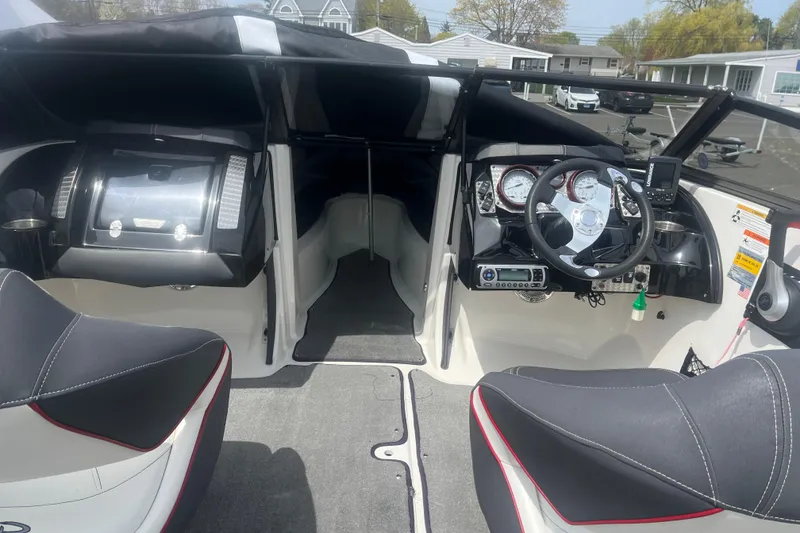 Slide: The Image of Interior view of a 2013 Larson LSR 2300 I/O boat cockpit with steering wheel and dashboard. - 7