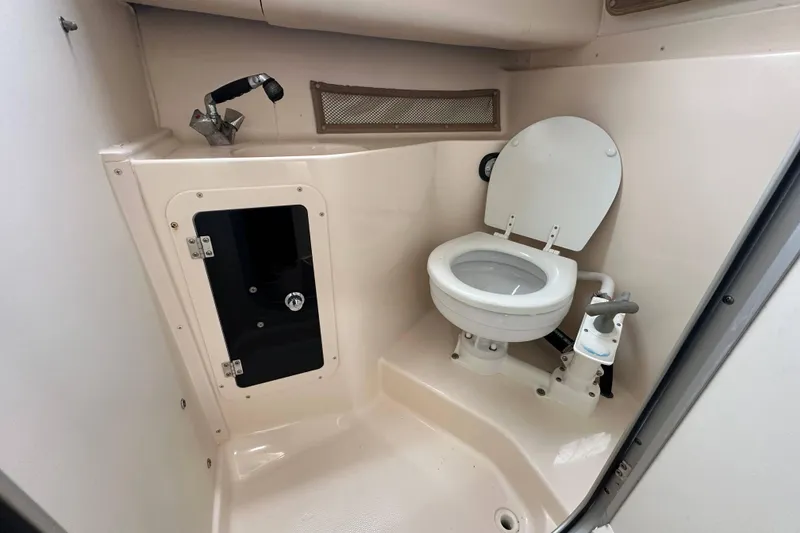 Slide: The Image of 2006 Grady-White Sailfish 282 boat bathroom with toilet and sink. - 12