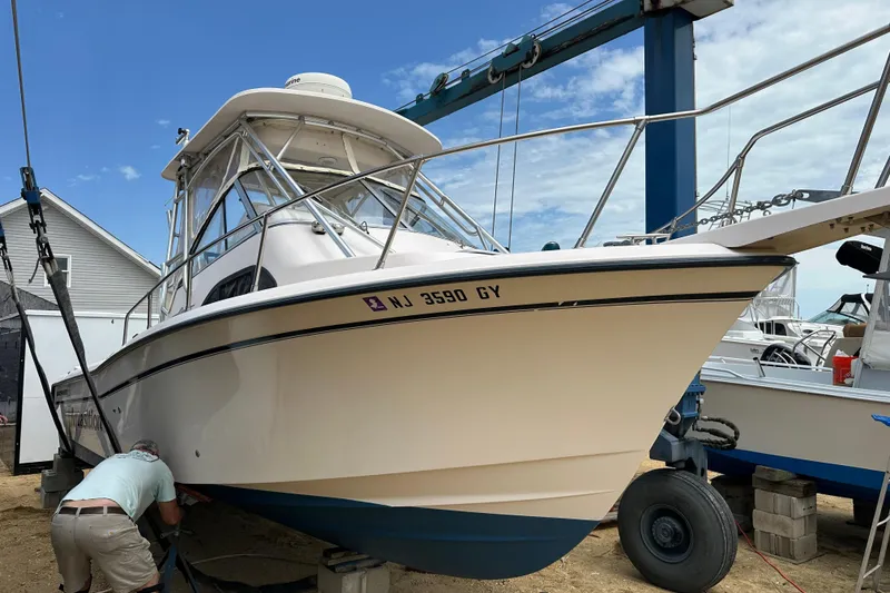 Slide: The Image of 2006 Grady-White Sailfish 282 boat on trailer, undergoing maintenance at a marina. - 17