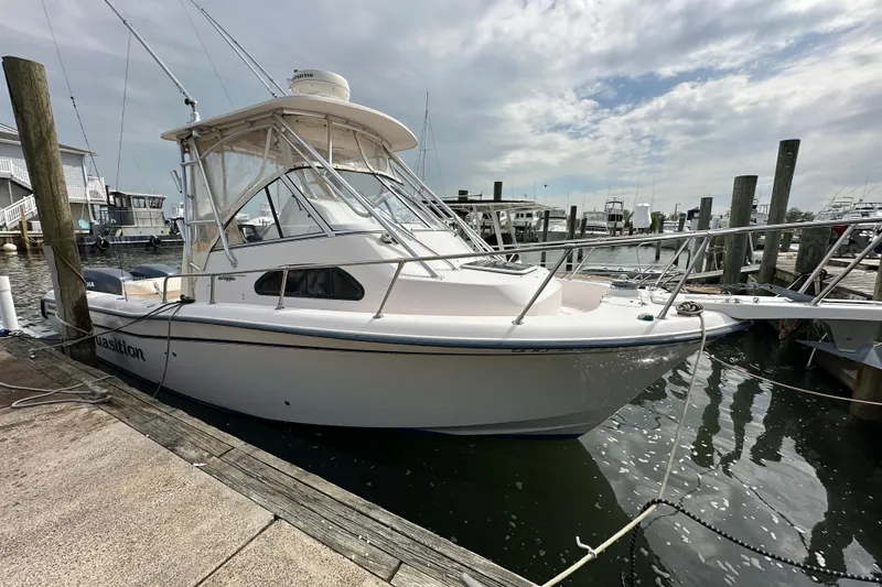 Slide: The Image of 2006 Grady-White Sailfish 282 boat docked at marina under cloudy sky. - 18