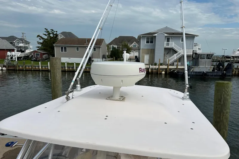 Slide: The Image of 2006 Grady-White Sailfish 282 boat with radar, docked in a marina. - 21