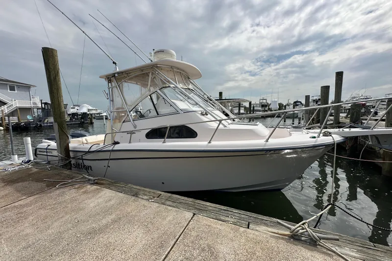 Slide: The Image of 2006 Grady-White Sailfish 282 boat docked at a marina under cloudy skies. - 6