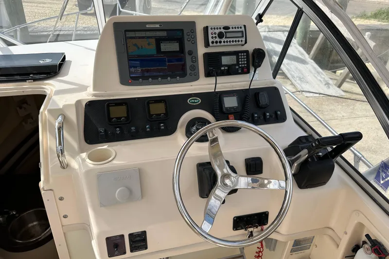 Slide: The Image of Helm of 2006 Grady-White Sailfish 282 with navigation equipment and steering wheel. - 7