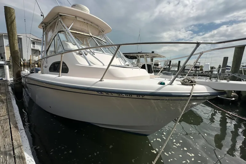 Slide: The Image of 2006 Grady-White Sailfish 282 boat docked at marina under cloudy sky. - 8
