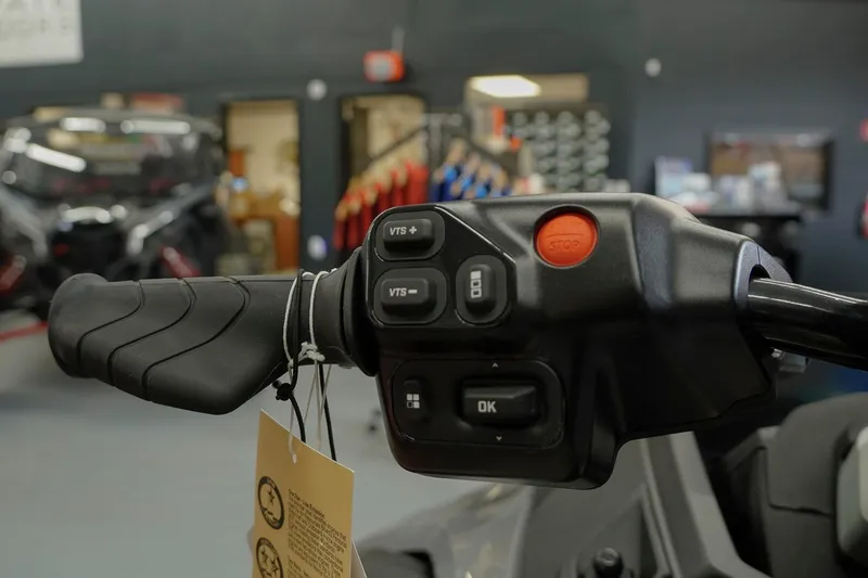Slide: The Image of Close-up of 2026 Sea-Doo FishPro Trophy 170 handlebar controls in a showroom. - 13