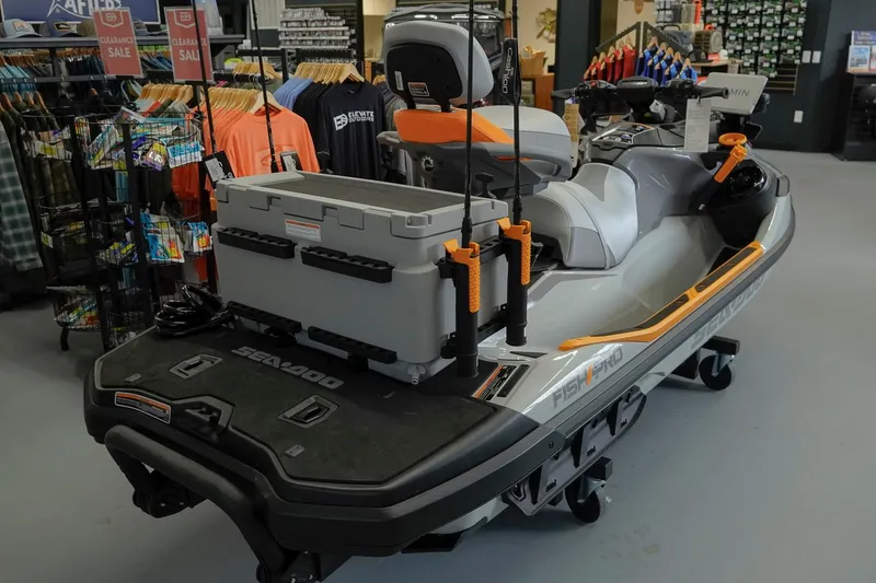 Slide: The Image of 2026 Sea-Doo FishPro Trophy 170 jet ski displayed in a showroom with fishing gear. - 3
