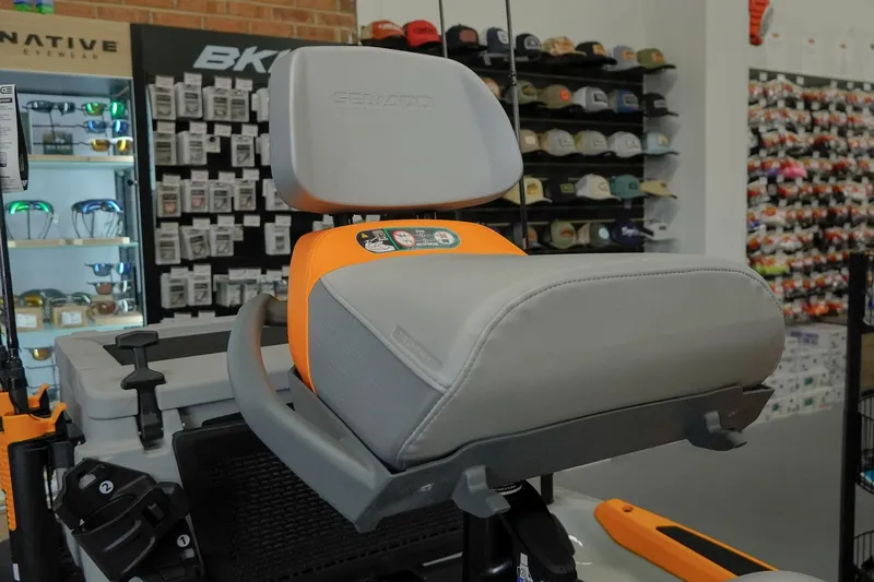 Slide: The Image of 2026 Sea-Doo FishPro Trophy 170 seat detail in a showroom with accessories display. - 6