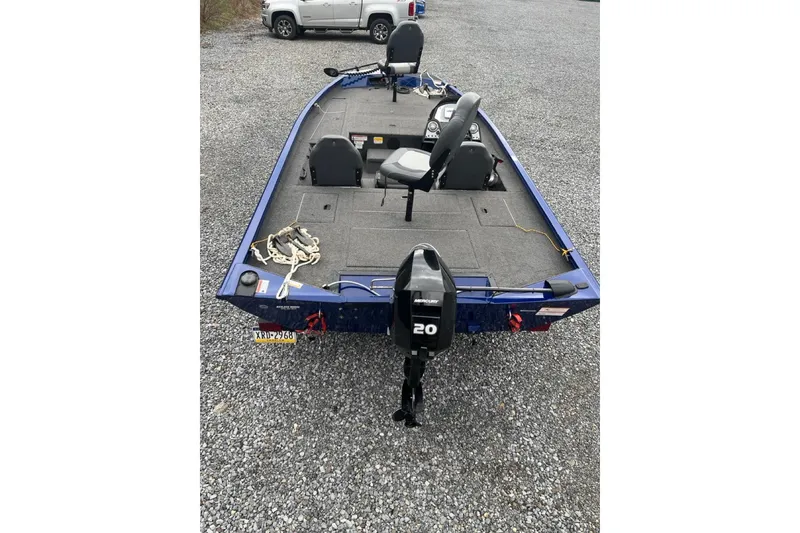 Slide: The Image of 2021 Lowe Stinger 175C boat with Mercury 20 engine on gravel surface. - 2