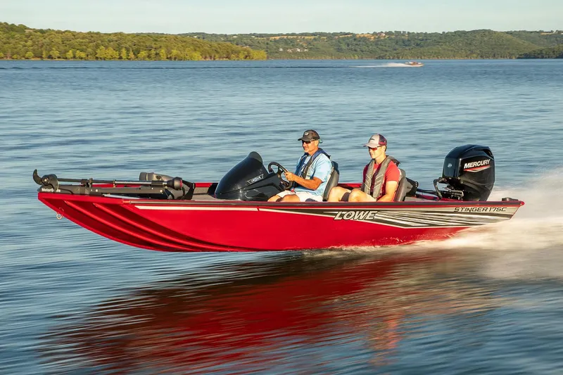 Slide: The Image of Manufacturer Provided Image: 2021 Lowe Stinger 175C boat cruising on a lake with two passengers. - 3