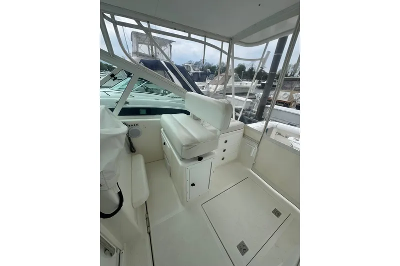 Slide: The Image of 2008 Cabo 32 Express boat interior with white seating and helm station. - 11