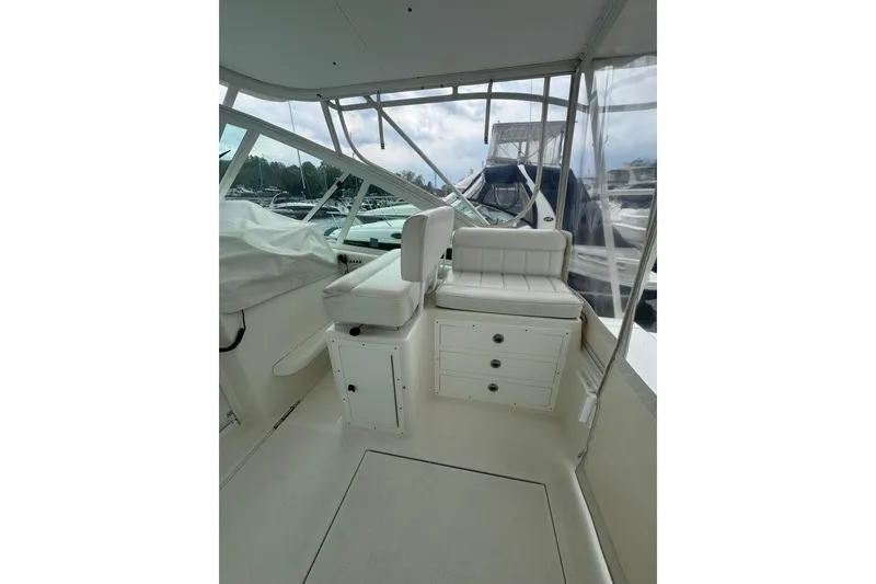 Slide: The Image of 2008 Cabo 32 Express boat interior with white seating and storage drawers. - 12