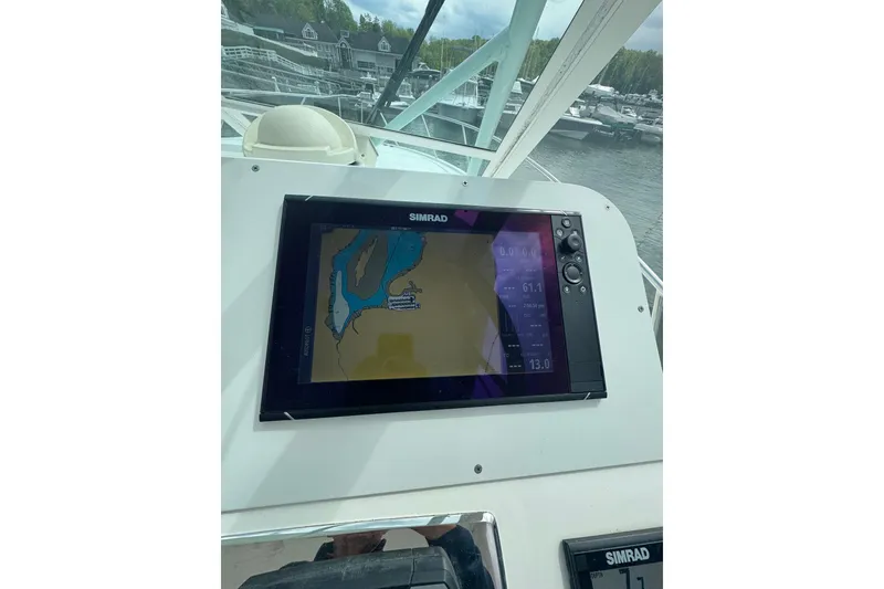 Slide: The Image of Simrad navigation display on 2008 Cabo 32 Express boat, docked near marina. - 15