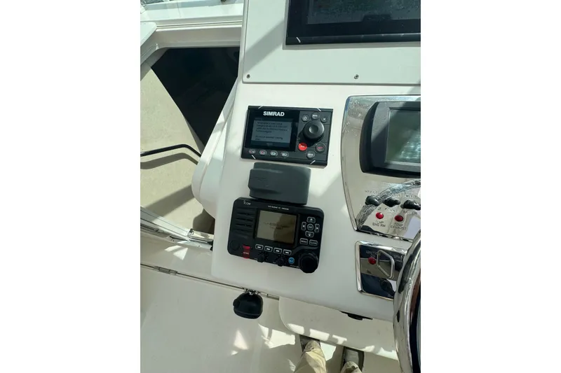 Slide: The Image of 2008 Cabo 32 Express boat dashboard with navigation and control systems. - 17
