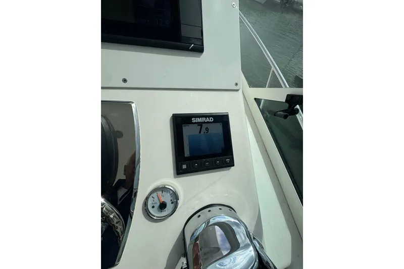 Slide: The Image of Dashboard of a 2008 Cabo 32 Express boat with Simrad display and gauge. - 19