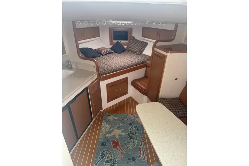 Slide: The Image of Interior of 2008 Cabo 32 Express boat with cozy cabin and nautical decor. - 20