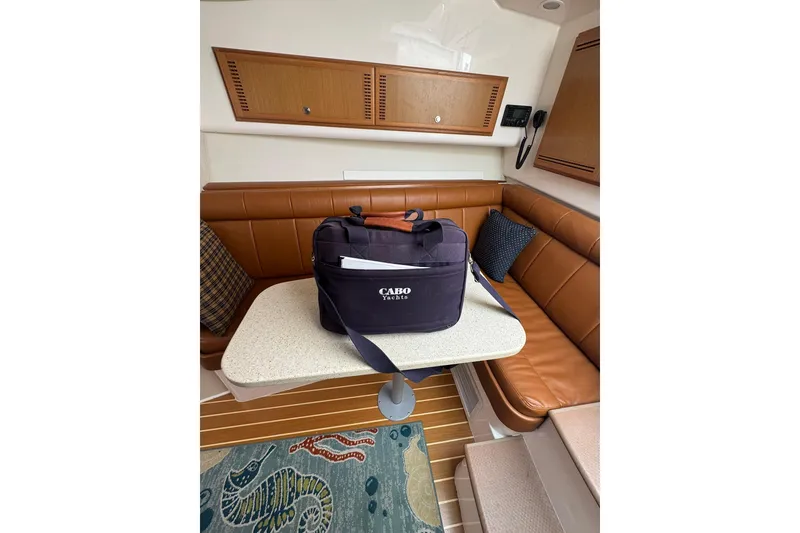 Slide: The Image of Interior of 2008 Cabo 32 Express yacht with a Cabo Yachts bag on the table. - 23