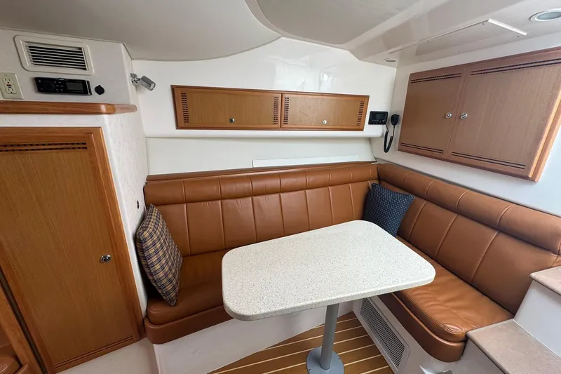 Slide: The Image of Interior of 2008 Cabo 32 Express boat with leather seating and wooden cabinetry. - 25
