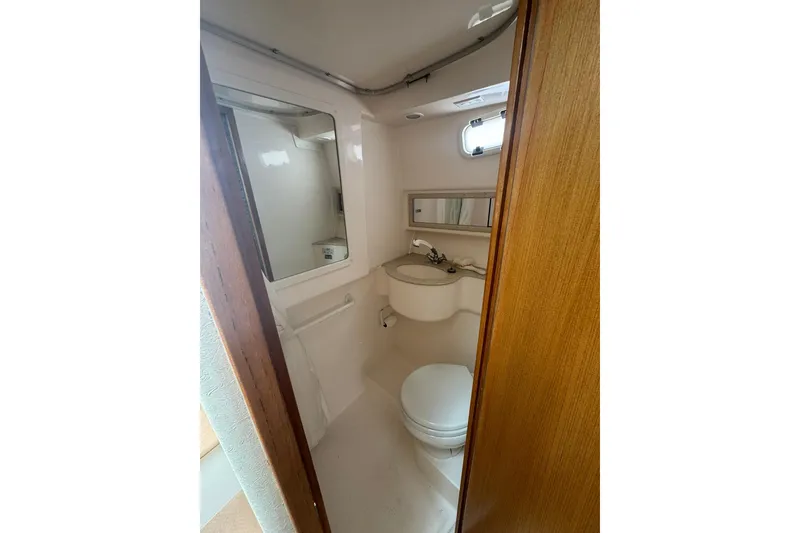 Slide: The Image of 2008 Cabo 32 Express boat bathroom with sink, toilet, and mirror. - 26