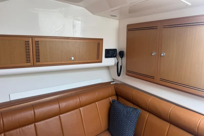 Slide: The Image of Interior of 2008 Cabo 32 Express boat with leather seating and wooden cabinets. - 29