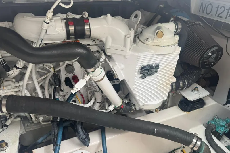 Slide: The Image of Engine compartment of a 2008 Cabo 32 Express boat, showcasing detailed mechanical components. - 30