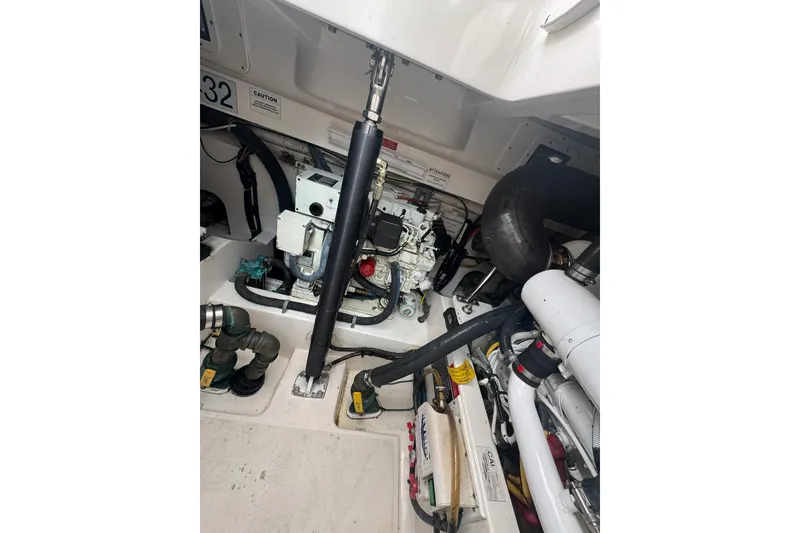 Slide: The Image of Engine compartment of a 2008 Cabo 32 Express boat, showcasing mechanical components. - 32