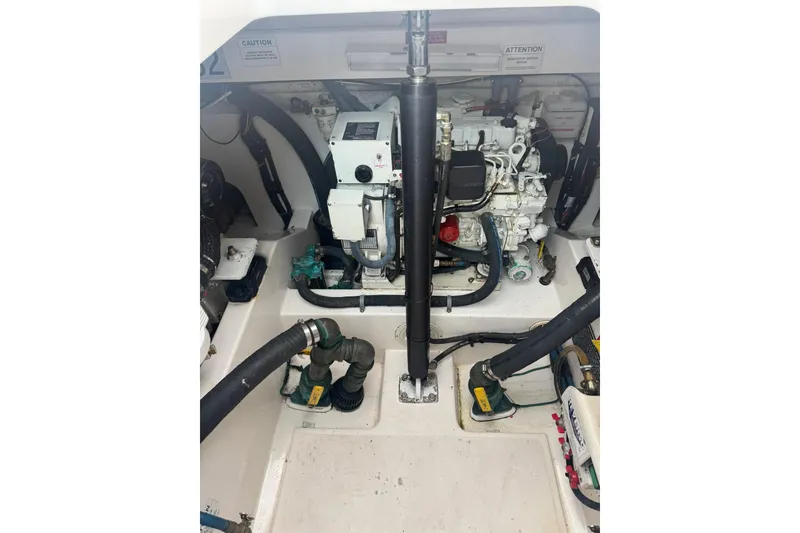 Slide: The Image of Engine compartment of a 2008 Cabo 32 Express boat, showcasing mechanical components. - 33