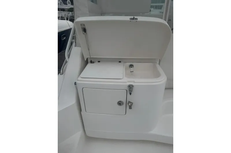 Slide: The Image of 2008 Cabo 32 Express boat sink and storage compartment. - 8