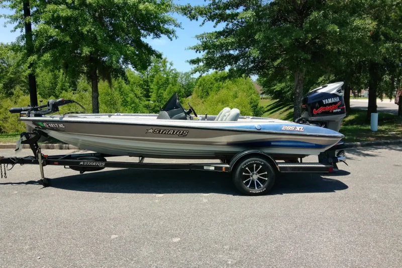 Slide: The Image of 2007 Stratos 285 XL boat on trailer, parked outdoors with trees in background. - 1