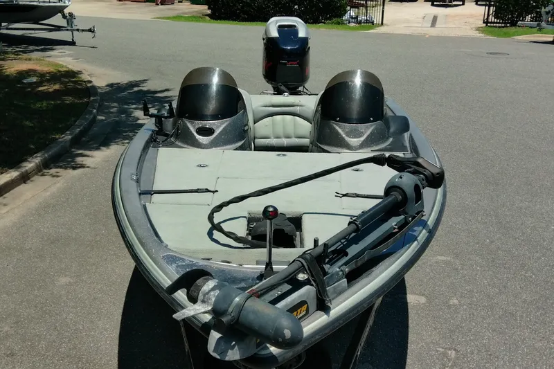 Slide: The Image of 2007 Stratos 285 XL boat with dual consoles and trolling motor, parked on pavement. - 2
