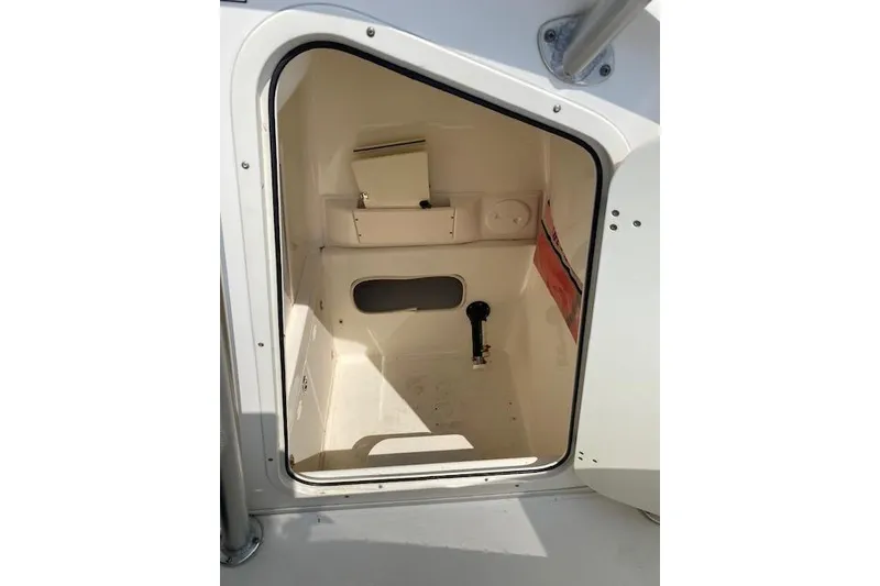Slide: The Image of 2007 Boston Whaler 240 Outrage cabin interior with storage compartments. - 11