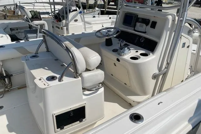 Slide: The Image of 2007 Boston Whaler 240 Outrage boat interior with helm and seating area. - 5