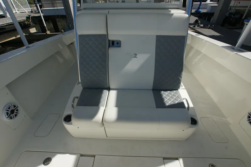 Slide: The Image of 2018 SeaVee 390Z boat interior with cushioned seating and cup holders. - 10