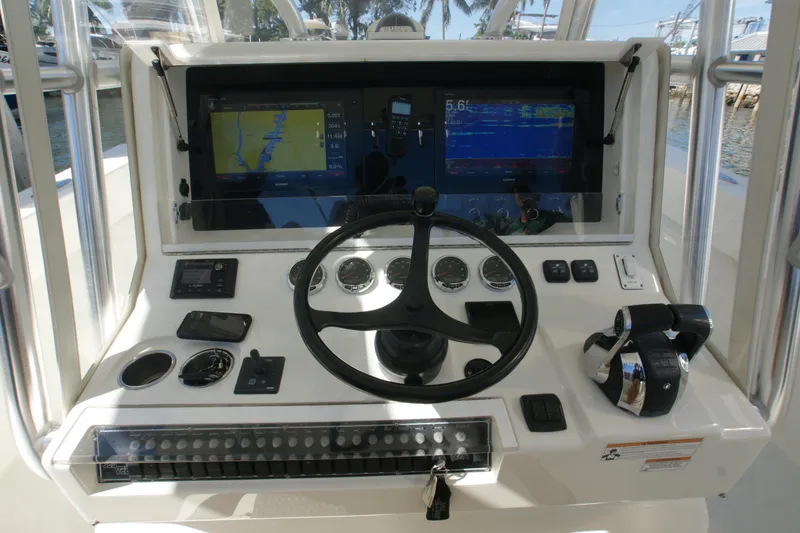 Slide: The Image of 2018 SeaVee 390Z boat dashboard with navigation screens and controls. - 13