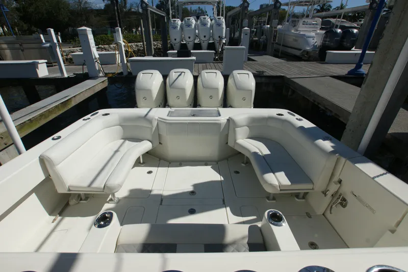 Slide: The Image of 2018 SeaVee 390Z boat with spacious seating and four powerful outboard engines at a dock. - 14