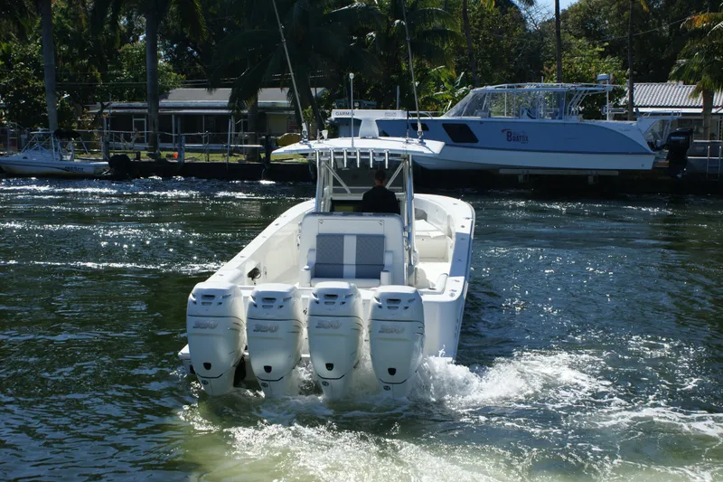 Slide: The Image of 2018 SeaVee 390Z boat with four engines cruising on a sunny waterway. - 5