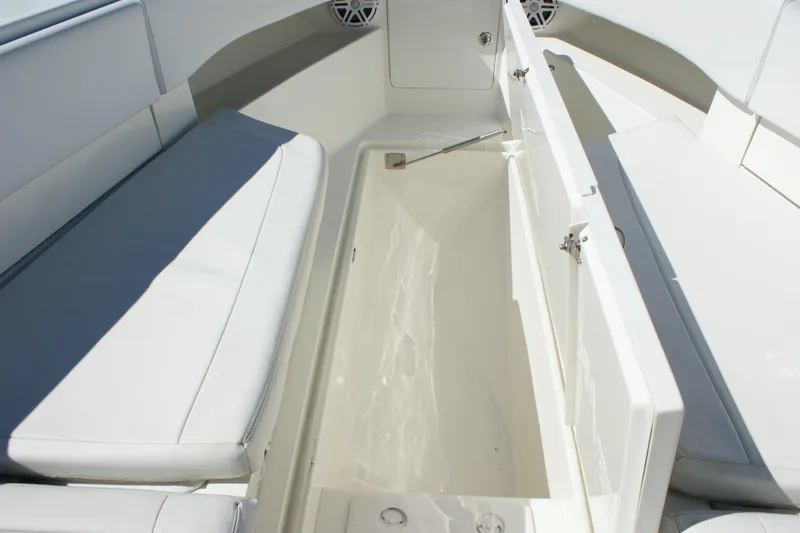 Slide: The Image of 2018 SeaVee 390Z boat interior with open storage compartment and cushioned seating. - 6