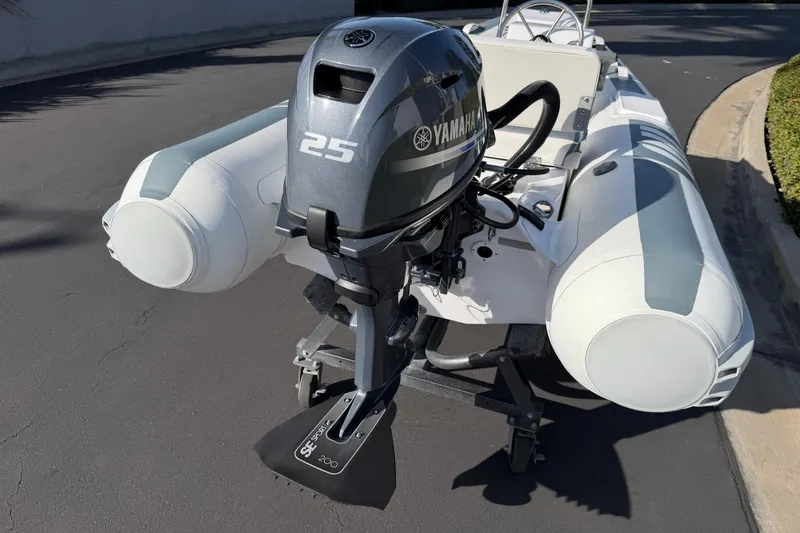 Slide: The Image of 2021 Novurania Deluxe 335 inflatable boat with Yamaha 25 outboard motor on a trailer. - 10