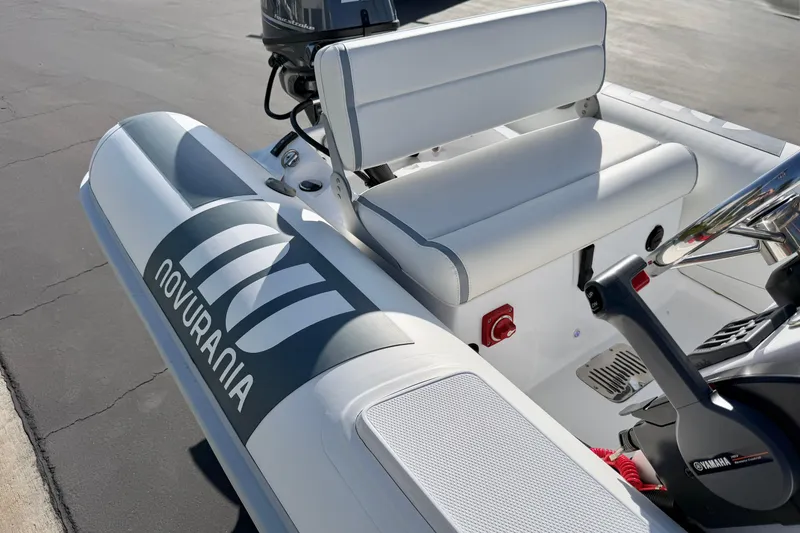 Slide: The Image of 2021 Novurania Deluxe 335 boat interior with Yamaha controls and seating. - 11