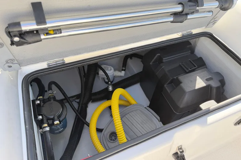 Slide: The Image of 2021 Novurania Deluxe 335 storage compartment with battery and pump system. - 15