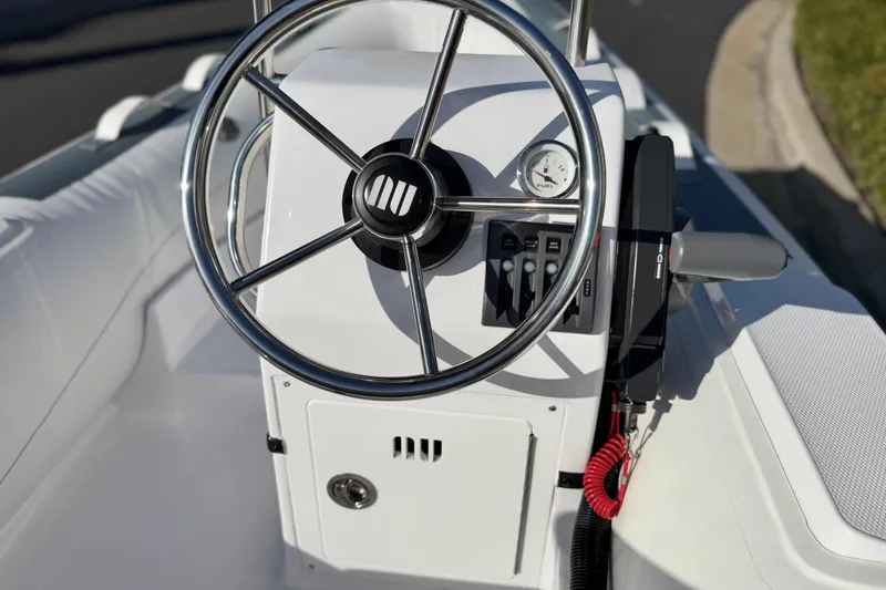 Slide: The Image of Steering console of 2021 Novurania Deluxe 335 boat with controls and gauges. - 17