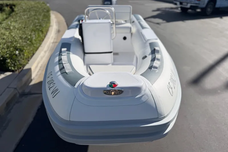 Slide: The Image of 2021 Novurania Deluxe 335 inflatable boat, white exterior, parked on pavement. - 19