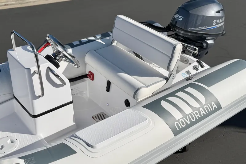 Slide: The Image of 2021 Novurania Deluxe 335 inflatable boat with Yamaha 25 outboard motor, sleek design. - 22